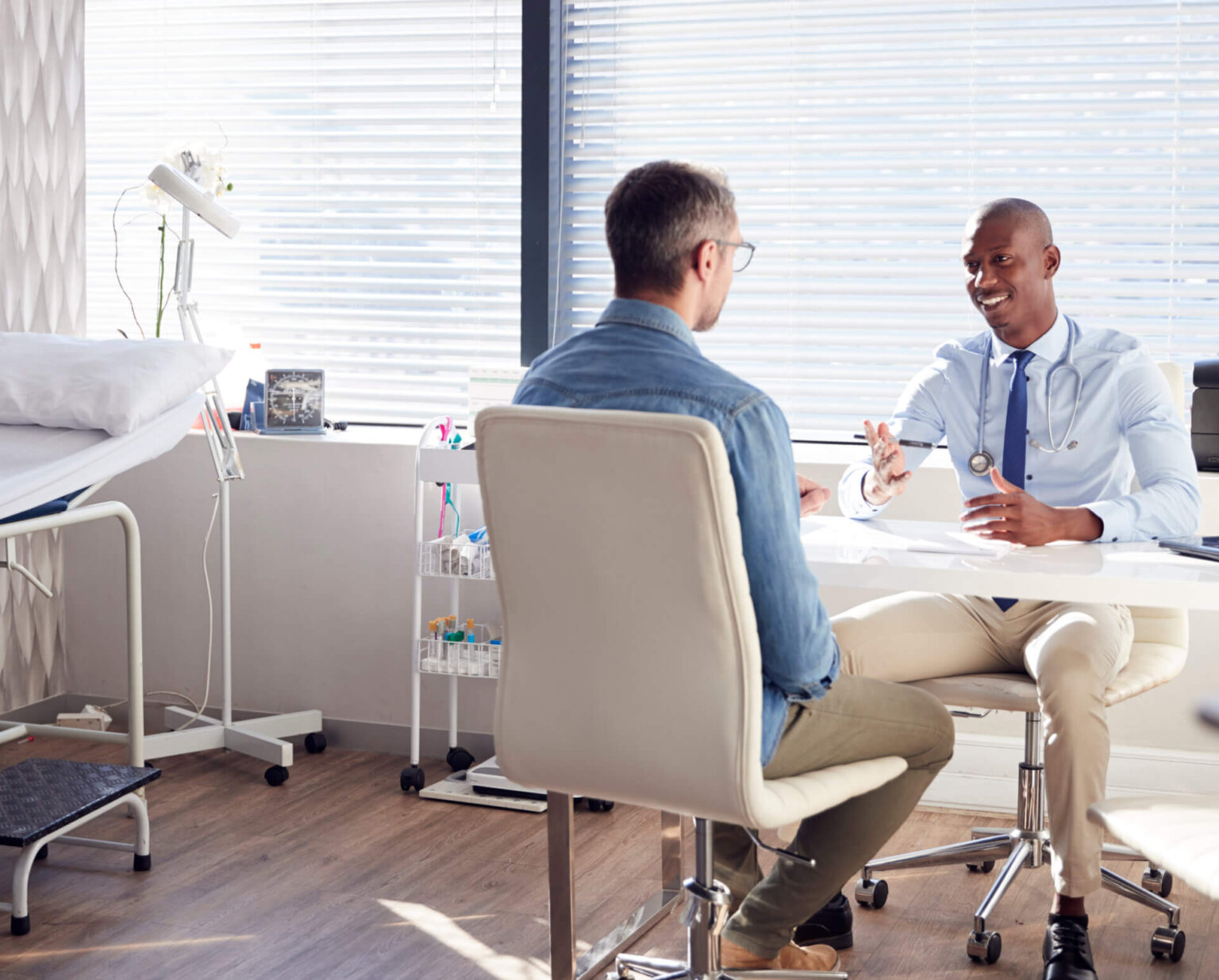 Man discussing treatment options with his healthcare provider at the point of care
