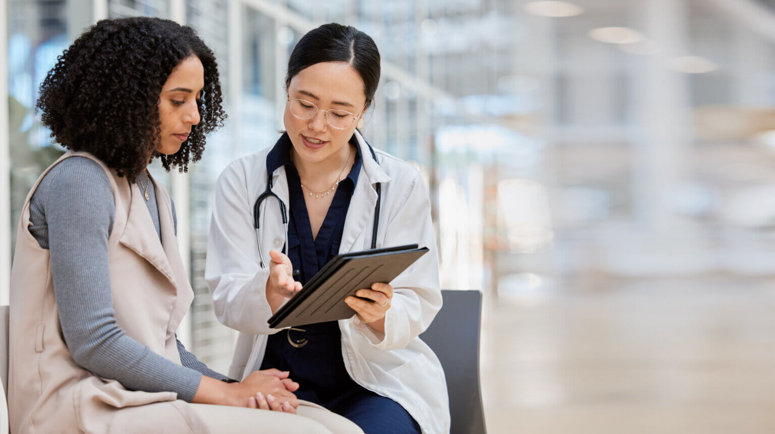 Female healthcare professional conducting a consultation and sharing recommendations with with a female patient at the point of care