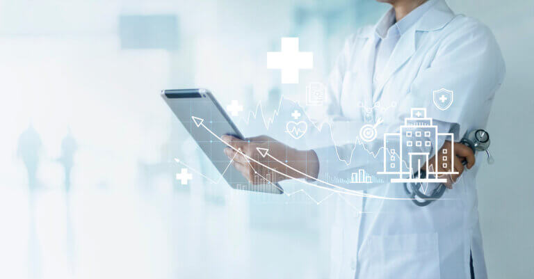 A healthcare provider holds a tablet analyzing a medical report with graphs and medical iconography displayed.